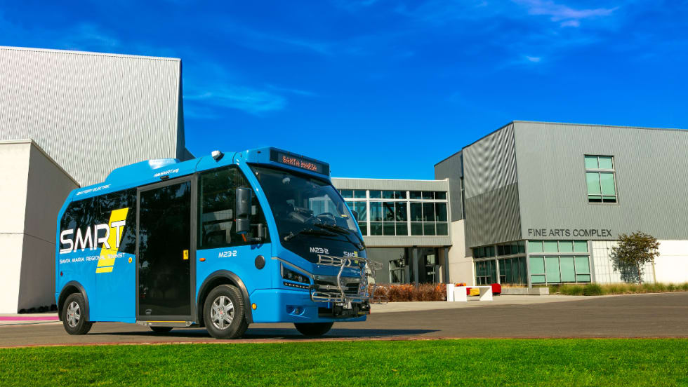 A blue SMRT Microtransit bus.
