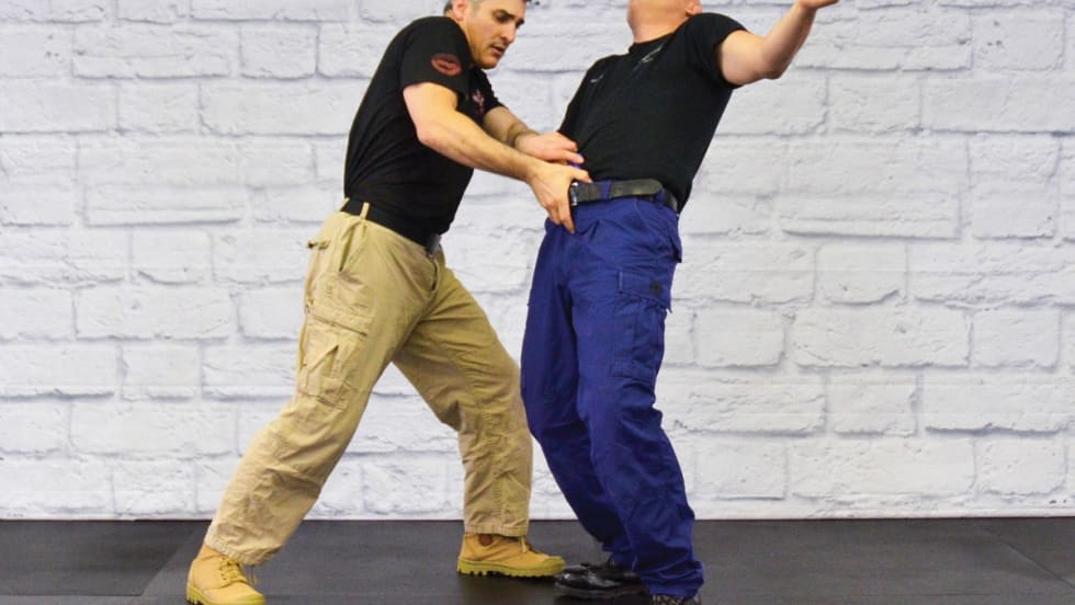 Police Krav Maga (Police KM) can be used for overall DT as well as to disarm a subject reaching for a weapon in the front of his waistband.[|CREDIT|]Photo: Rinaldo Rossi and Mimi Rowland