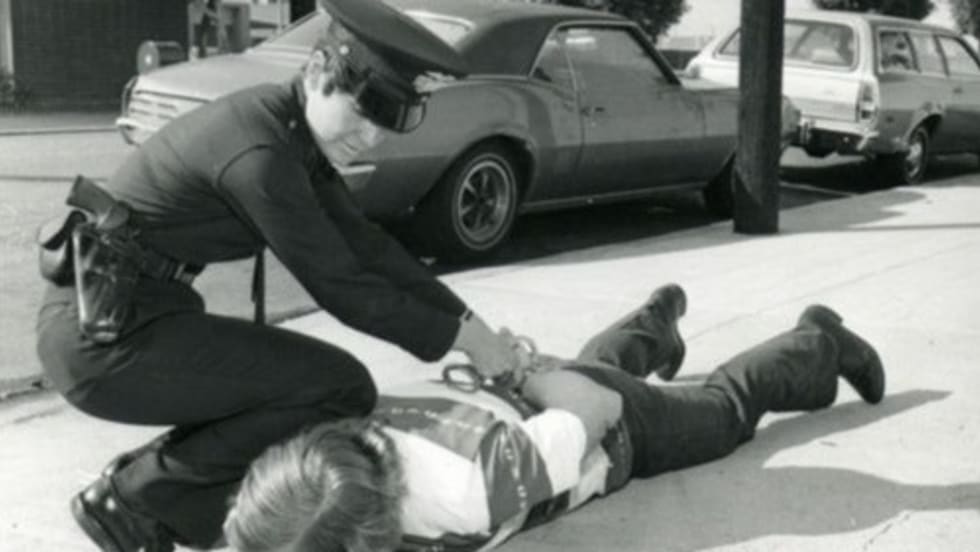 A female police officer makes an arrest in the 1980s. Photo courtesy of Los Angeles Police Historical Society.