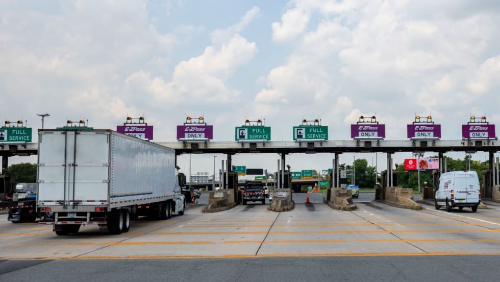 Trucks at a highway tolling station.