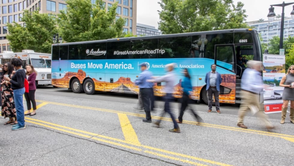 A Great American Road Trip motorcoach bus at an event.
