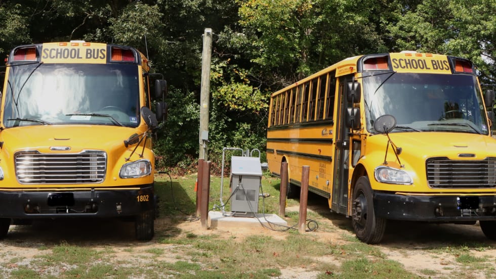 Two school buses parked next to each other. 