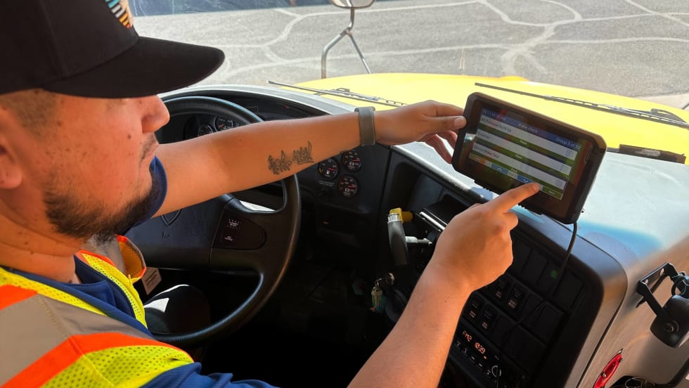 A driver managing his routing tablet