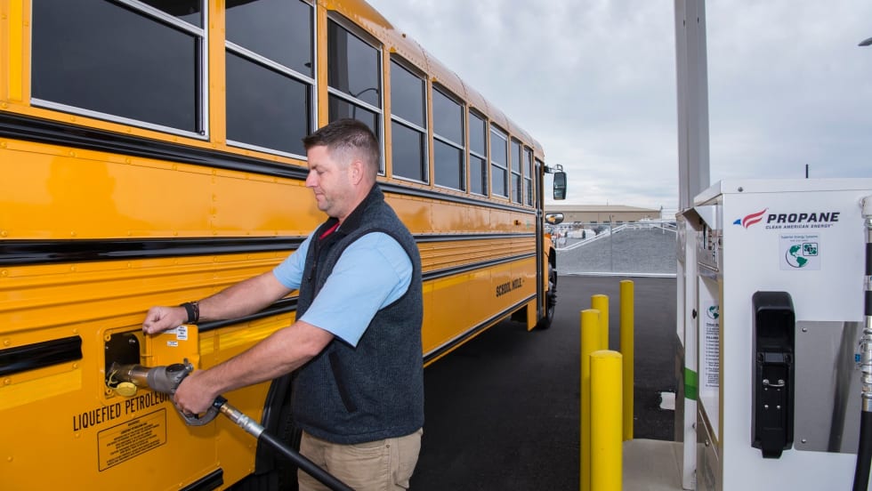 a school bus refuels at a propane station