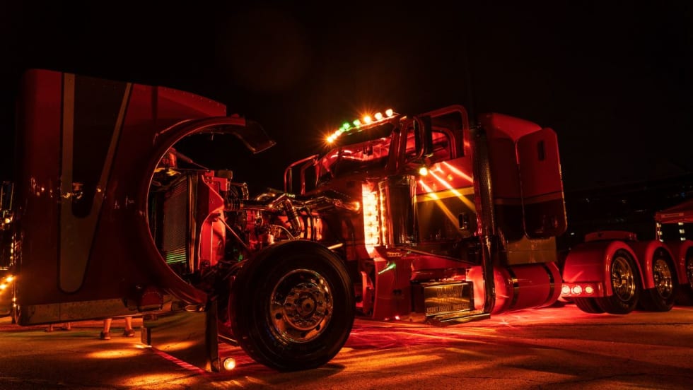 Peterbilt truck lit up at night.