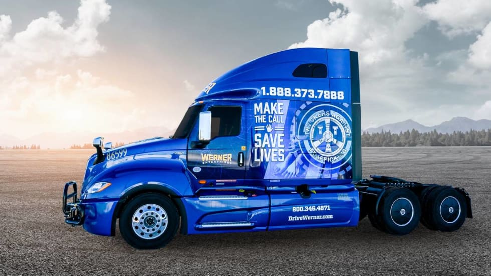 Blue Werner heavy-duty truck tractor with TAT human trafficking prevention wrap