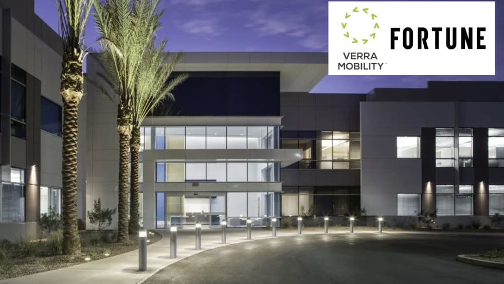 the exterior of an office building with two logos