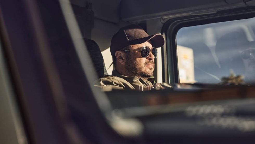 Trucker driving a Volvo VNL.