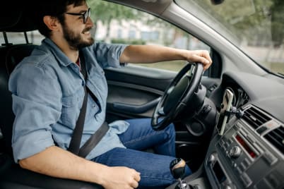 man smiling while driving