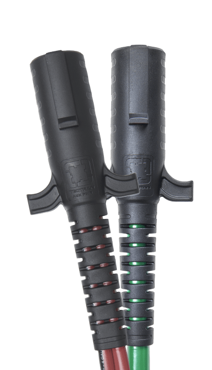 Two heavy-duty electrical connectors with ergonomic black rubber grips and ribbed strain reliefs, featuring red and green spiral wire guides. Each connector is marked with the brand "Tectran" and has integrated thumb grips for easy handling.