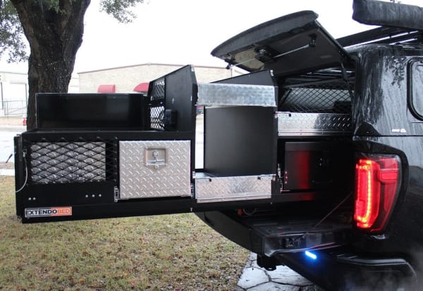 Truck bed storage system with open compartments and diamond plate panels