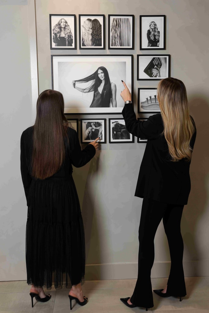 Terra Harvell and Colleague look at a portrait wall