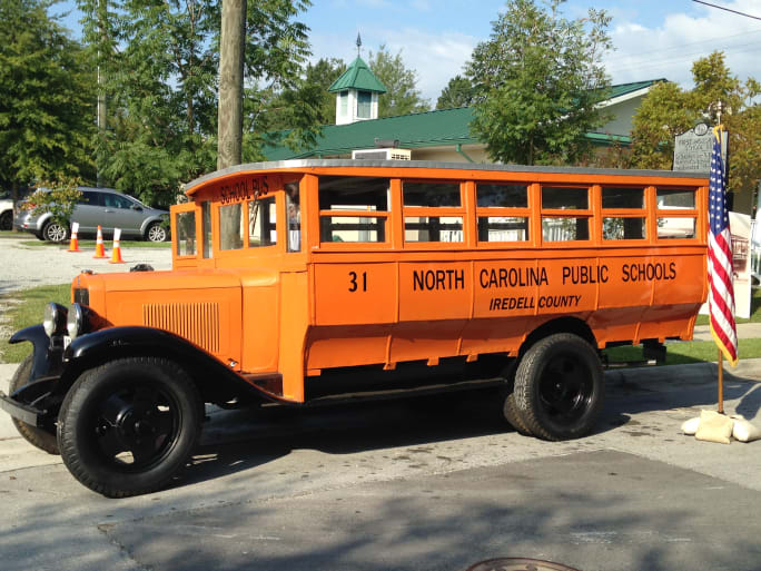 A 1931 North Carolina school bus in an orange color, prior to the yellow color standardization.