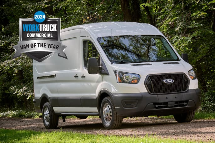 A white Ford Transit van with green trees in background and Work Truck Commercial Van of the Year 2024 badge.
