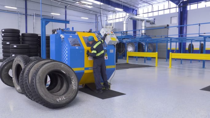 A technician on a high-pressure tire tester