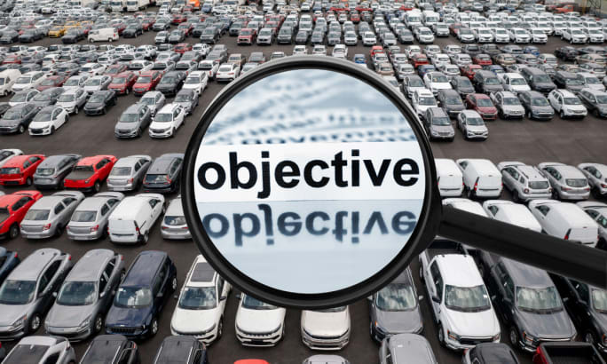 Mixed parking lot with magnifying glass that says 