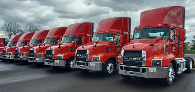 Row of shiny new red Mack trucks