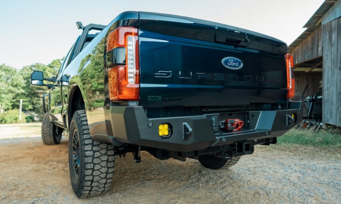 view of rear bumper and tailgate of a large black pickup truck.