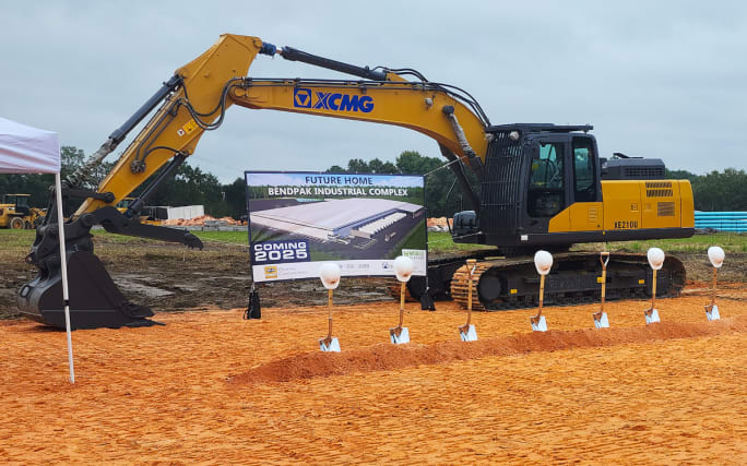 Construction excavator in front of a construction site.