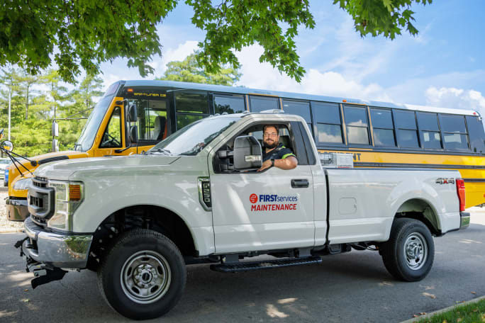 a pickup truck in front of a school bus