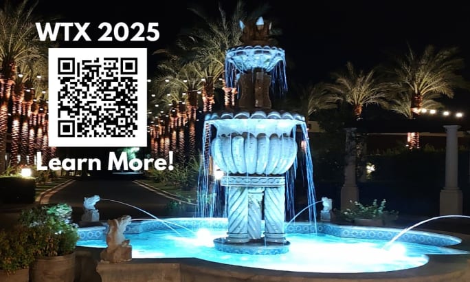 night photo of a water fountain with QR code for information on WTX 2025