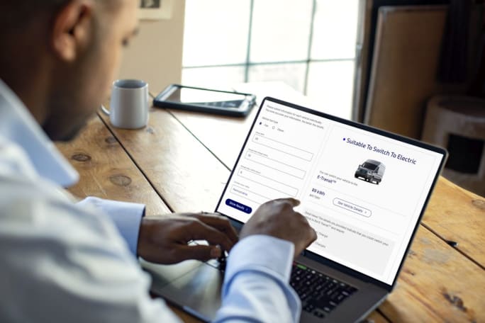 Man on laptop looking at Ford Pro's E-Switch Assist