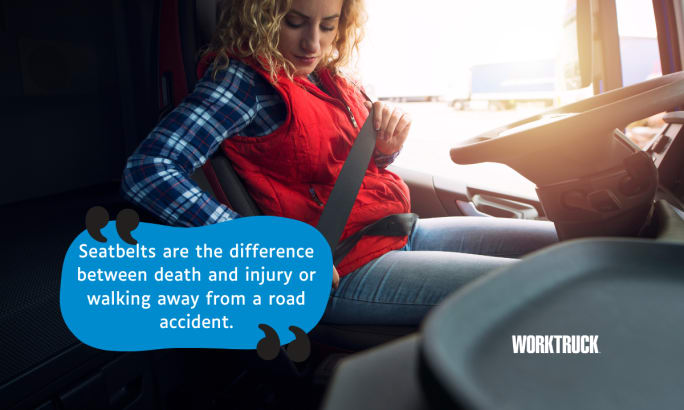 A woman buckling up her seat belt in the front seat of a truck