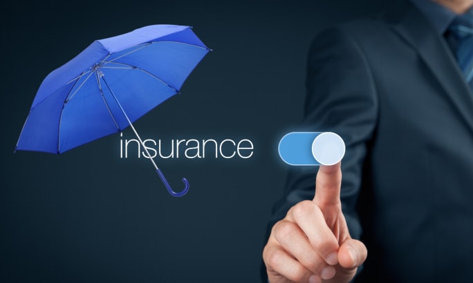 A business man touching the screen with insurance under an umbrella.