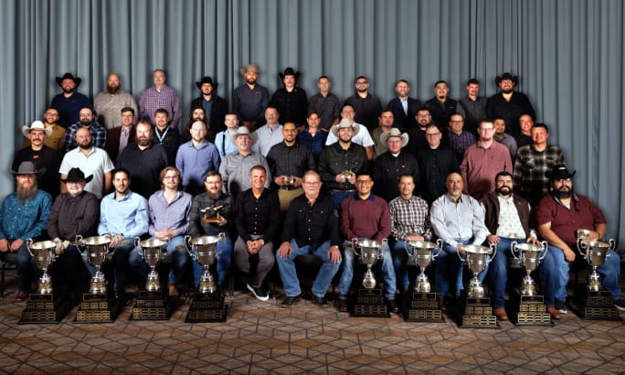 Group photo of winners with trophies and awards.