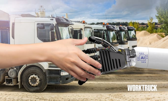 A human hand and robot hand with AI shake in front of a fleet of trucks.