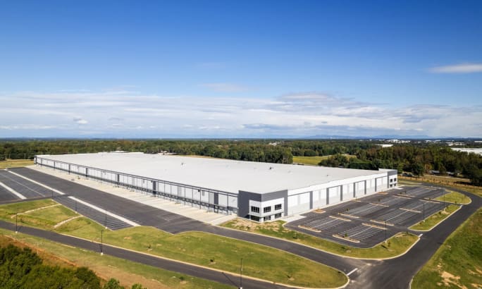 Aerial view of a large white manufacturing building.