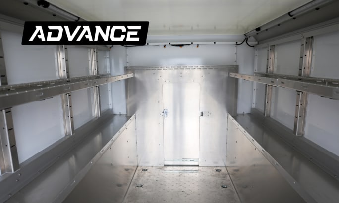 View of the interior of an enclosed service truck, looking toward the open rear doors.