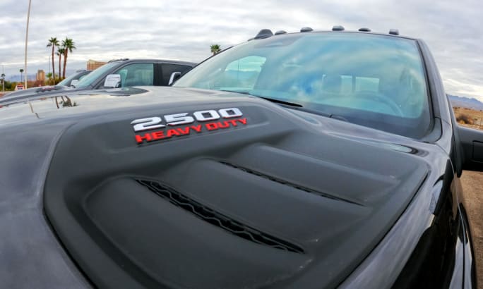 Close up photo of the hood of a black truck.