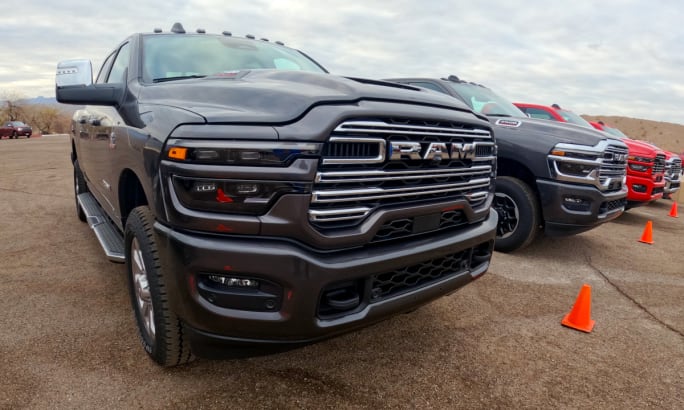Angled photo showing the grilles of several trucks parked side by side.