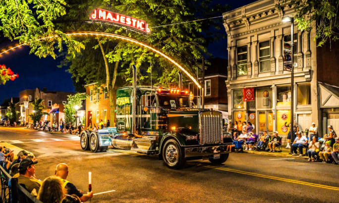 Truck in a parade at night.