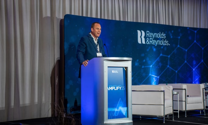 Chris Walsh, president and acting CEO of Reynolds and Reynolds, speaks at the Amplify 2025 Retail Summit.
