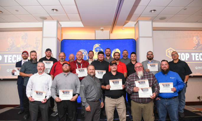 Group photo of Cox Automotive Top Tech 2025 finalists holding certificates on stage.