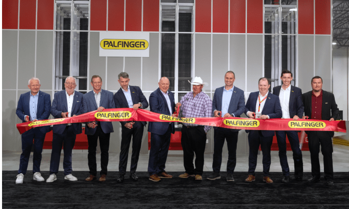 Business leaders cut ribbon to open a PALFINGER facility.