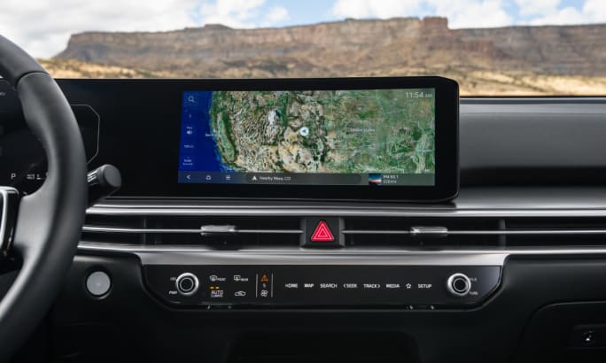 Dashboard of the 2026 Kia Sorento Hybrid showing a wide navigation display and center controls.