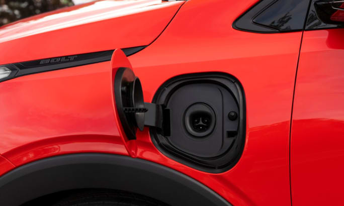 Close-up of charging port on red Chevrolet Bolt showing native NACS connector.
