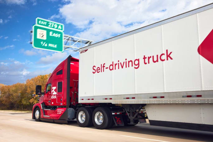 Red Kodiak autonomous truck pulling trailer that says