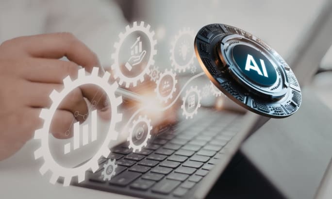Hands typing on a laptop with digital gears and an AI icon, representing integrated fleet technology, automation, and responsible AI decision-making in 2026.