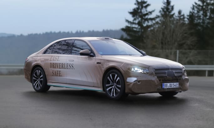 Mercedes-Benz S-Class robotaxi prototype driving on a roadway during autonomous vehicle testing.