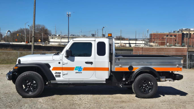 Front three-quarter view of the Acela Dispatcher 4x4 compact work truck with extended cab and aluminum flatbed, designed for fleet use in construction, utilities, and municipal operations.
