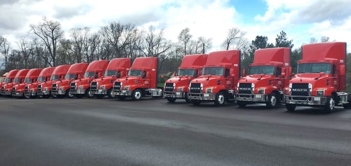 Line of red Mack trucks