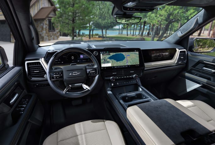 Interior view of the 2027 Chevrolet Silverado 1500 showing the digital instrument cluster, center touchscreen, passenger display, and center console.