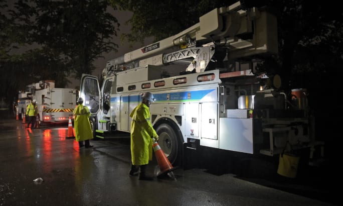 Crew preps disaster area with bucket truck.