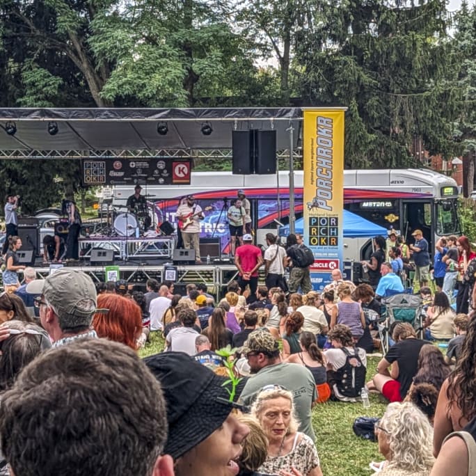 The crowd at 2026 PorchROKR’s Mainstage that’s being powered by a fully-electric METRO bus behind it.