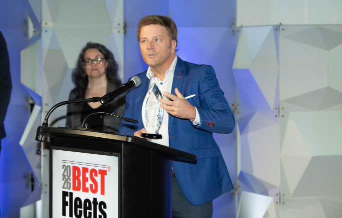 Man in blue suit at podium