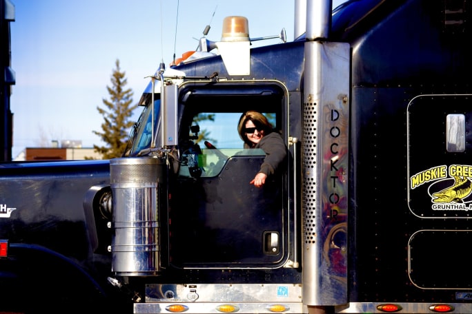 Ice Road Truckers' Lisa Kelly behind the wheel of a class black Kenworth truck